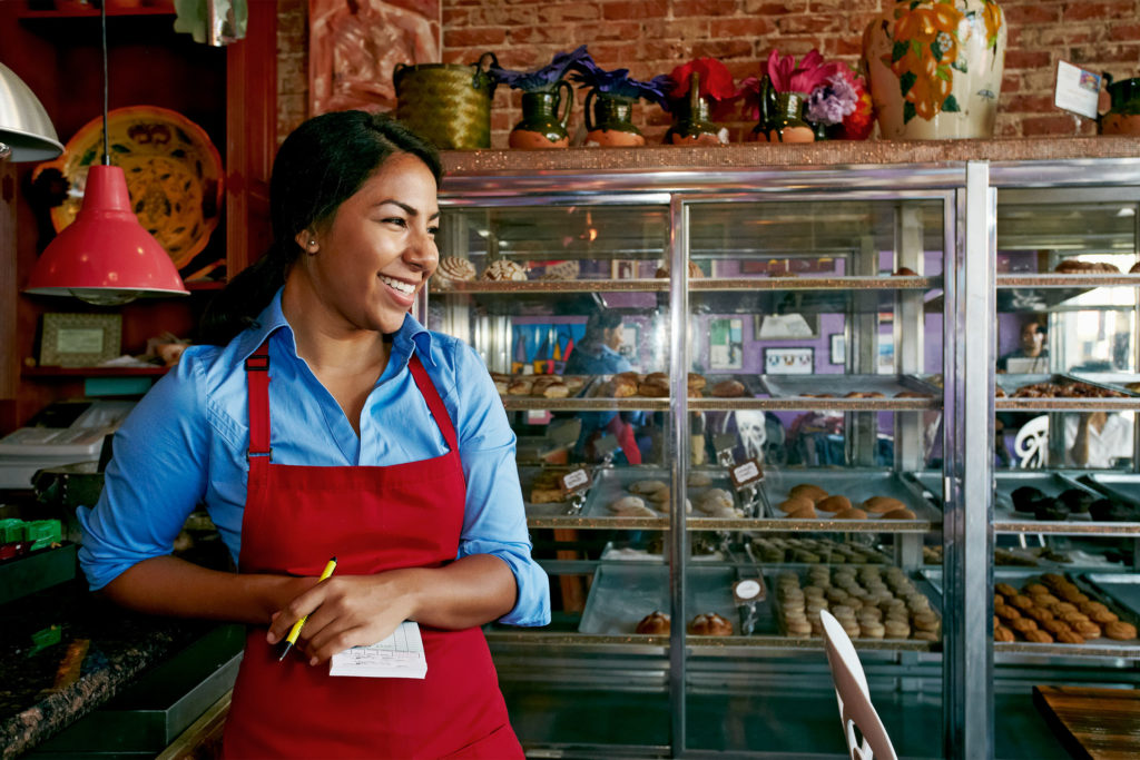 photo of smiling woman in bakery